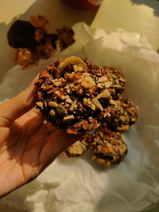 a person holding a piece of food in their hand, rocky roads, listing image, it's night, handcrafted