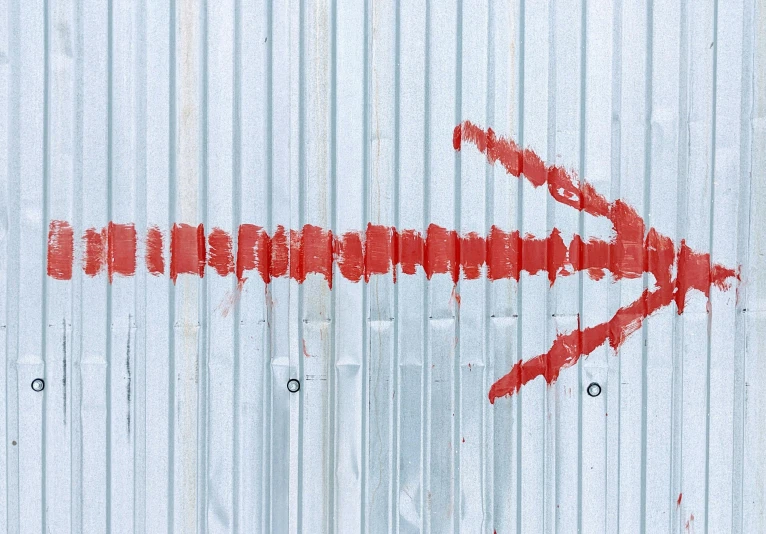 a red arrow painted on the side of a building, trending on pexels, oil lines, silver red, artistic illustration, metal shutter