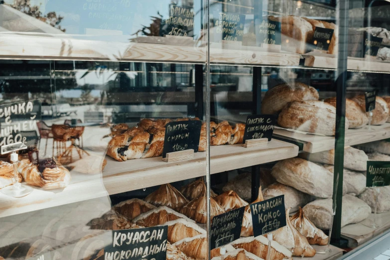 a display case filled with lots of baked goods, by Emma Andijewska, trending on unsplash, fan favorite, russia, exterior shot, lots of sunlight