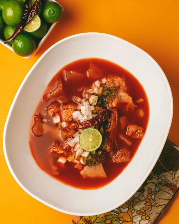 a bowl of soup sitting on top of a table, by Alejandro Obregón, bowl filled with food, reds, thumbnail, naga