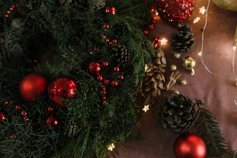 a close up of a christmas wreath on a table, pexels contest winner, a large sphere of red energy, pine color scheme, closeup - view, multiple stories