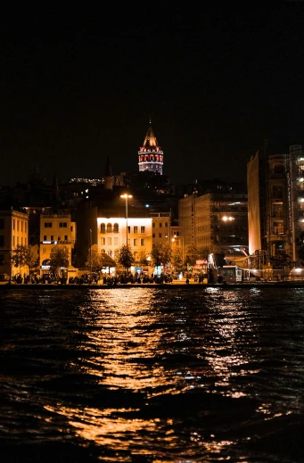 a large body of water next to a city at night, istanbul, the photo was taken from a boat, square, cinematic shot ar 9:16 -n 6 -g
