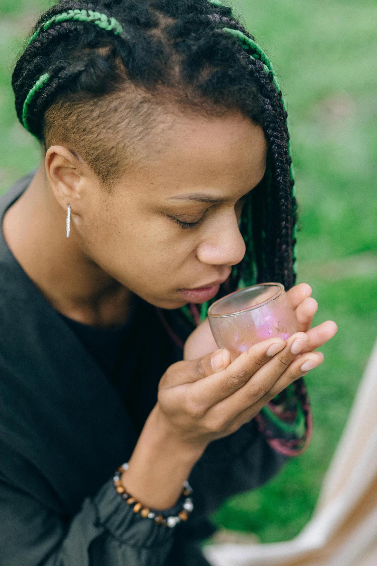 a close up of a person holding a cell phone, she is in the potions workshop, peacefully drinking river water, afropunk, in the garden