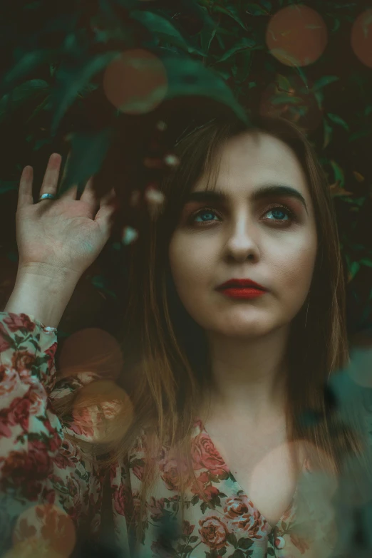 a woman standing in front of a tree, inspired by Elsa Bleda, pexels contest winner, renaissance, brown hair and large eyes, green and red tones, photo of young woman, shrugging