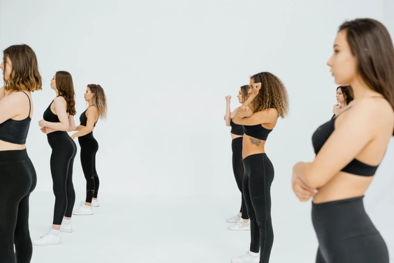 a group of women standing in front of a mirror, trending on pexels, figuration libre, black leggins, in front of white back drop, animation, half body photo