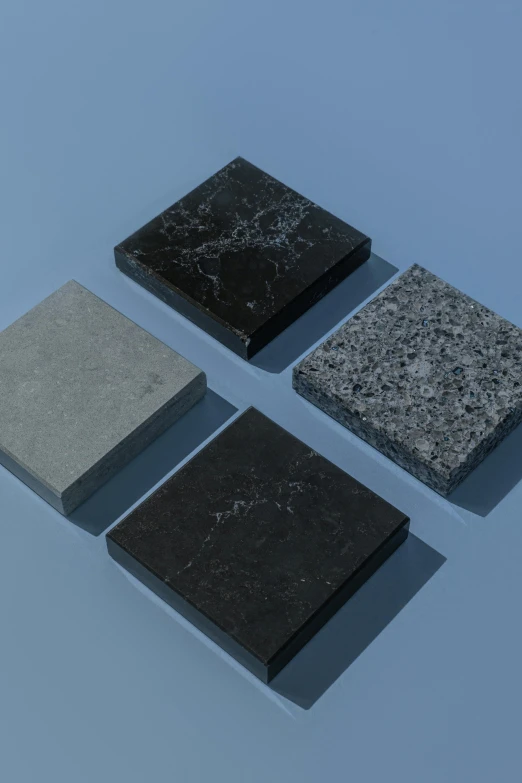 four different types of granite on a blue surface, a 3D render, by Harvey Quaytman, unsplash, black marble, square shapes, realistic 3d model, black squares on 4 corners