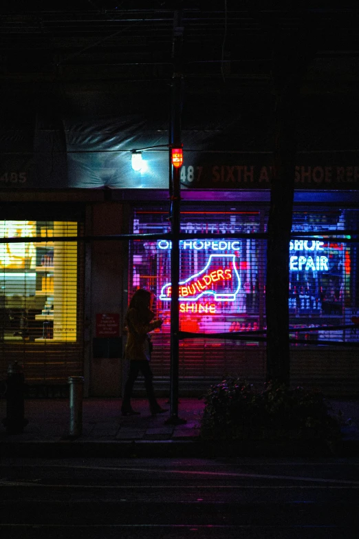 a person walking down a street at night, cyberpunk art, inspired by Elsa Bleda, storefront, colorful signs, drugstore, sci - fi scene future new york