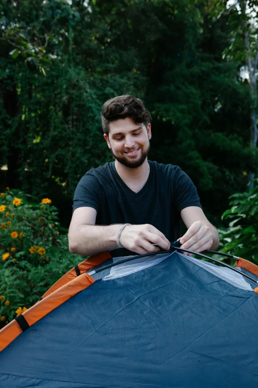 a man that is sitting inside of a tent, smiling down from above, jontron, in the garden, instructions