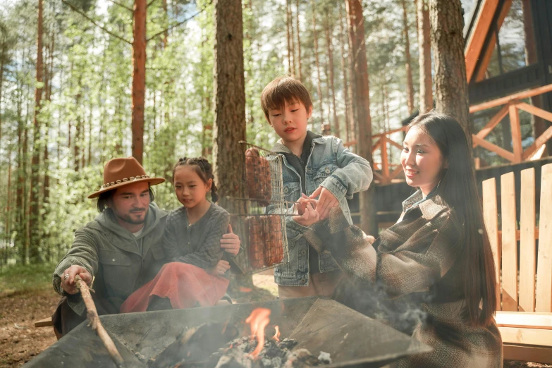 a group of people sitting around a fire pit, by Jaakko Mattila, pexels contest winner, hurufiyya, forest picnic, cowboy, family dinner, avatar image