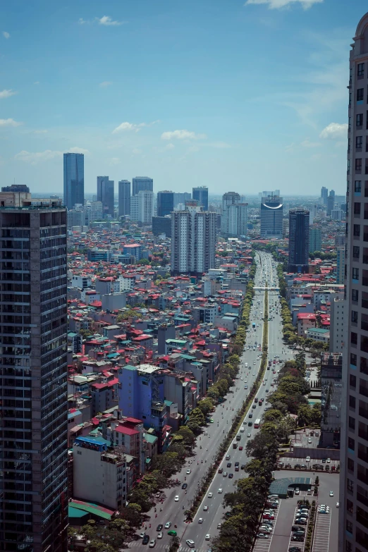 a view of a city from a tall building, by Sam Dillemans, long chin, square, low quality photograph, travel