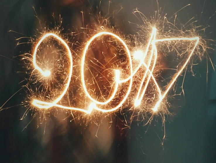 a woman holding sparklers in front of her face, pexels, 2017, handwriting title on the left, unkown year, bright thin wires