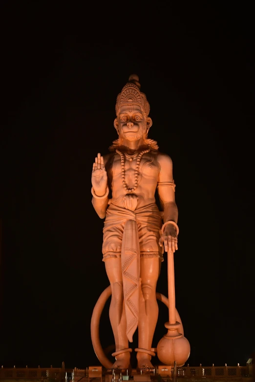 a large statue sitting on top of a lush green field, inspired by Ram Chandra Shukla, zbrush central, in front of a black background, at nighttime, single clay museum sculpture, photograph taken in 2 0 2 0