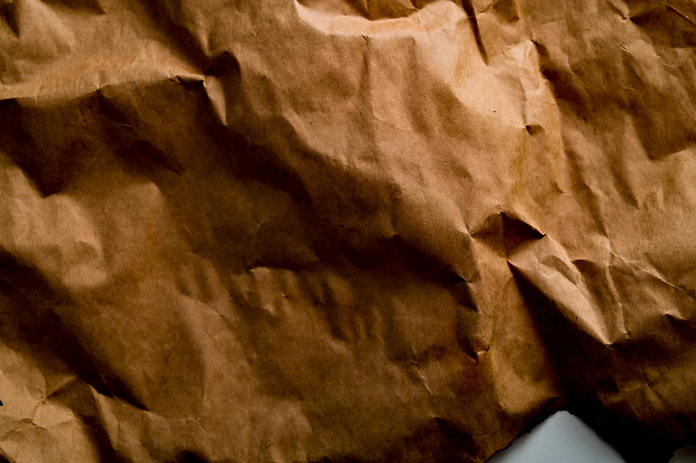 a laptop computer sitting on top of a piece of brown paper, intricate wrinkles, detailed product image, zoomed in, delicious