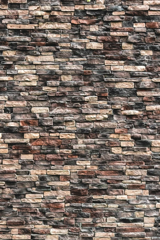 a fire hydrant in front of a brick wall, a digital rendering, by artist, shutterstock, baroque, stylized stone cladding texture, brown, multicolor, made of stone