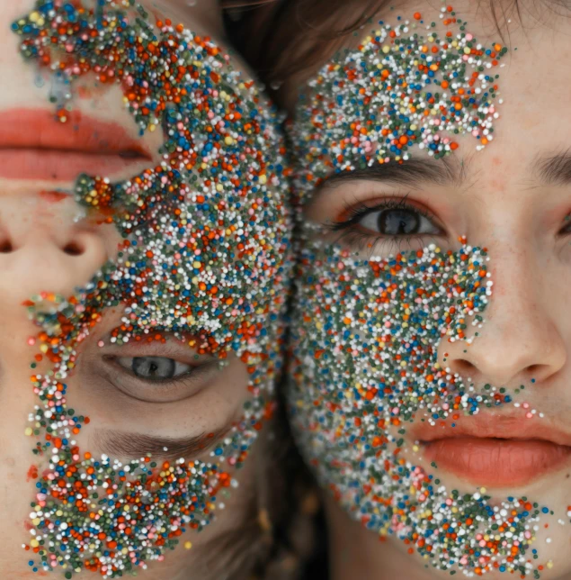 two girls with their faces covered in sprinkles, by Attila Meszlenyi, trending on pexels, detailed face with mask, mirrored, focus close on dreaming eyes, druillet colorful
