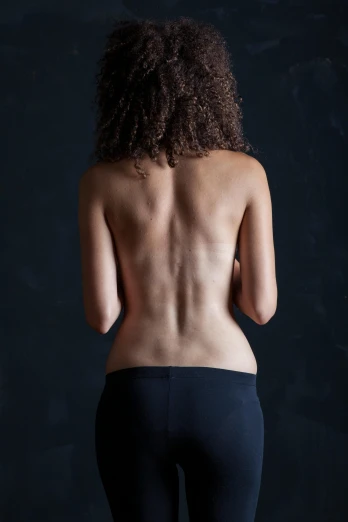 a woman standing with her back to the camera, by David Palumbo, medical photography, paul barson, black, flat curves