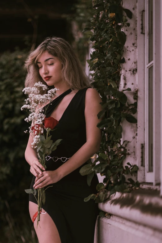 a woman in a black dress holding a flower, an album cover, inspired by Elsa Bleda, pexels contest winner, aestheticism, side portrait of imogen poots, rose garden, sleeveless, a young asian woman