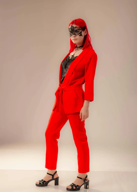 a woman in a red suit posing for a picture, trending on pexels, on a mannequin. high resolution, bright trouser suit for a rave, villain wearing a red oni mask, red tie