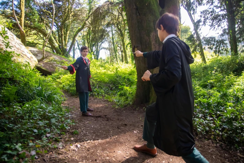 a couple of people that are standing in the woods, harry potter style, mage duel, on location, avatar image