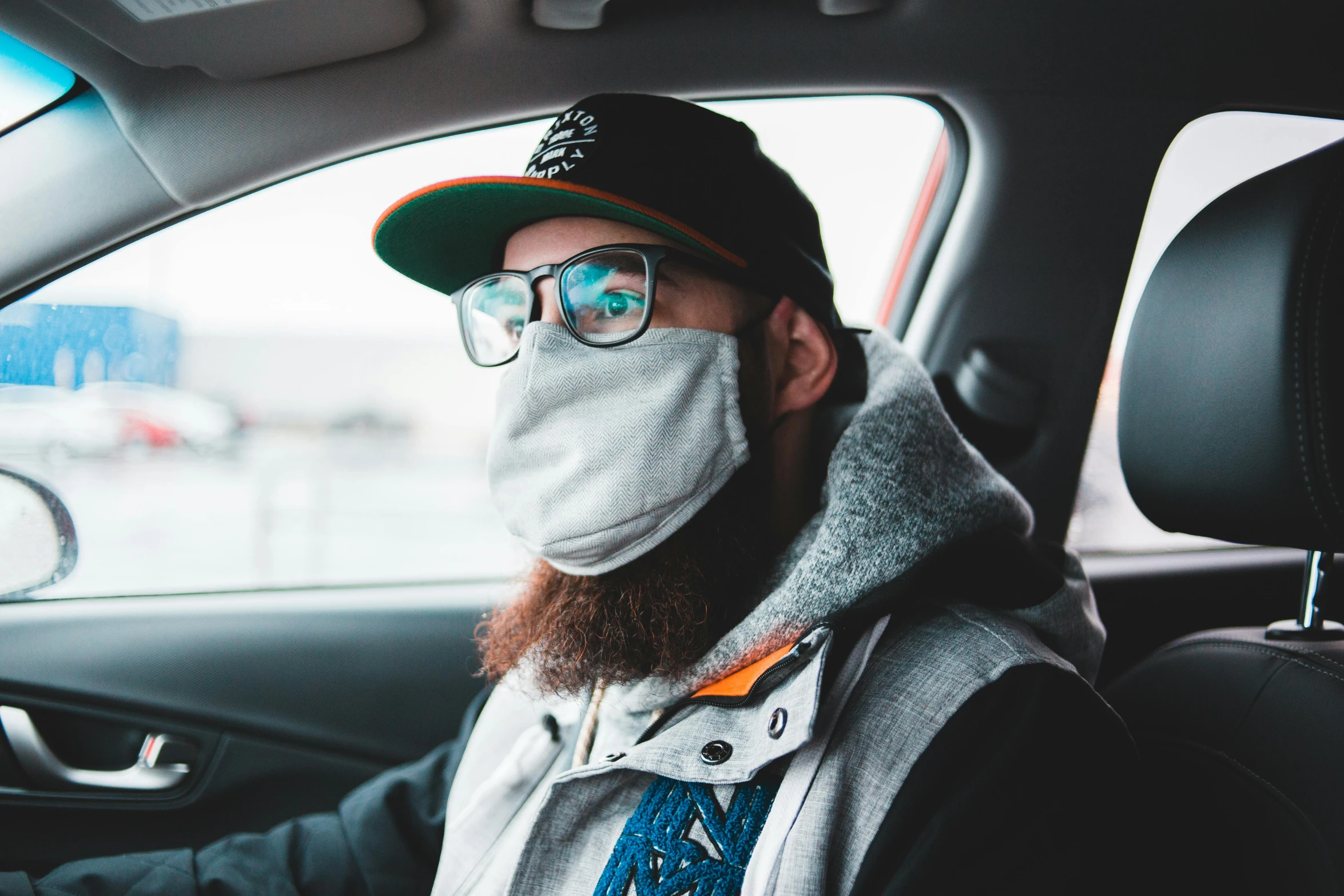 a man sitting in a car wearing a face mask, by Adam Marczyński, trending on pexels, ginger bearded man with glasses, action bronson, discord profile picture, sick with a cold