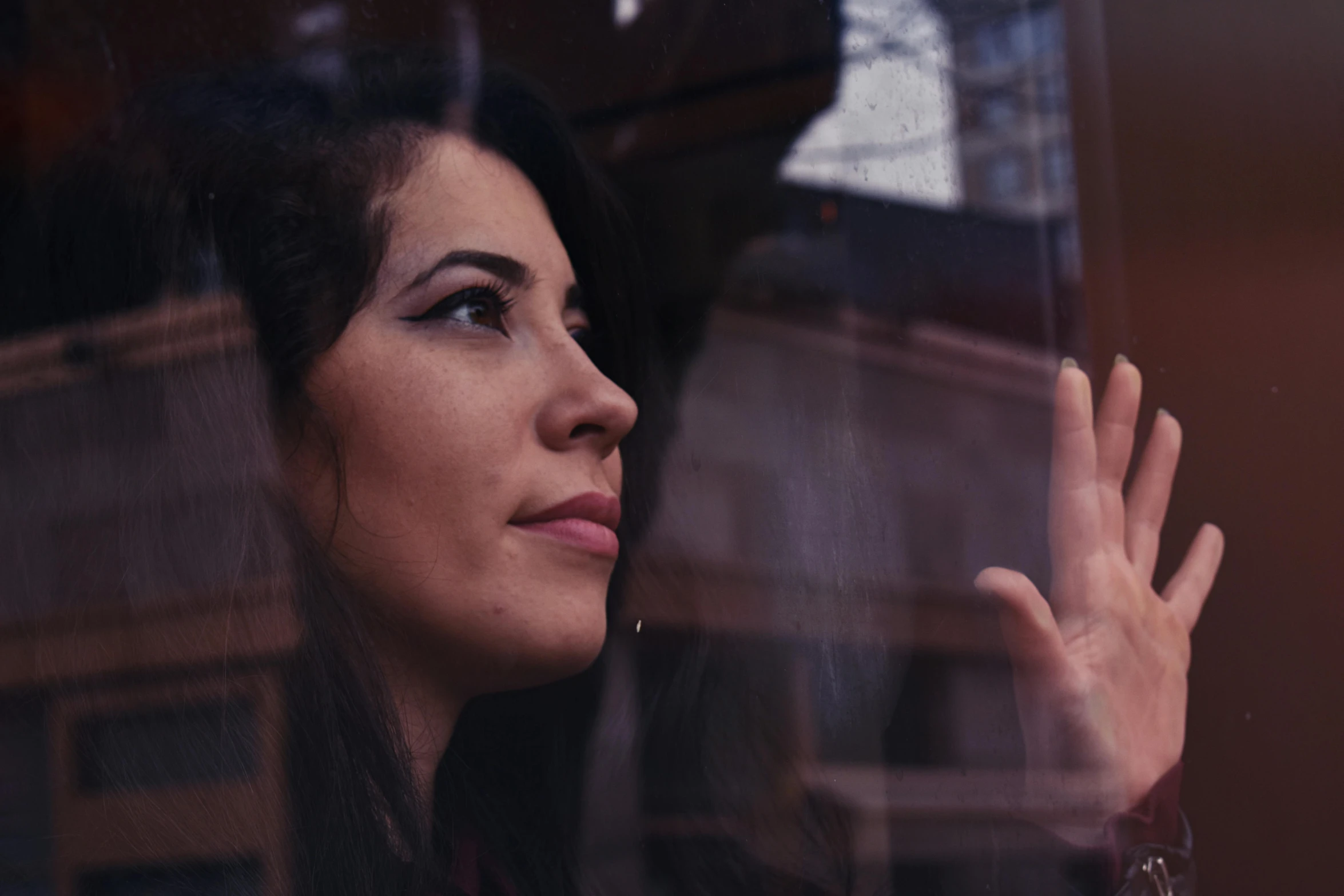 a close up of a person looking out a window, meni chatzipanagiotou, solemn gesture, music video, soft portrait shot 8 k