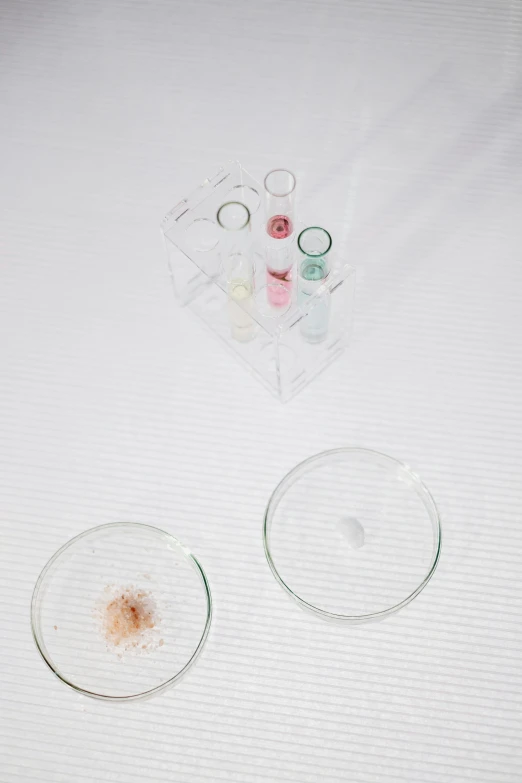 a couple of glasses sitting on top of a table, an album cover, inspired by Damien Hirst, unsplash, molecular gastronomy, powder, rinko kawauchi, detail