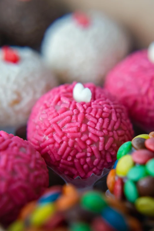 a close up of a box of cupcakes with sprinkles, inspired by david rubín, pexels, pop art, featuring pink brains, made of candy and lollypops, mexico, with an intricate