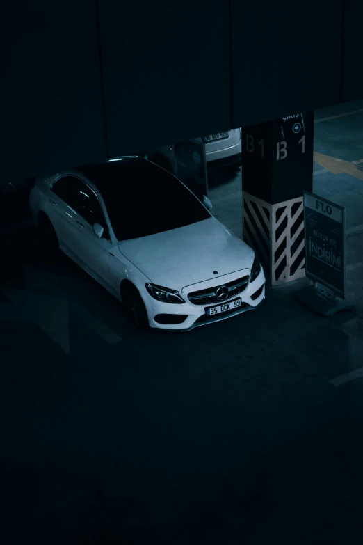 a white car parked in a parking garage, inspired by Elsa Bleda, pexels contest winner, mercedez benz, square, white on black, [ cinematic