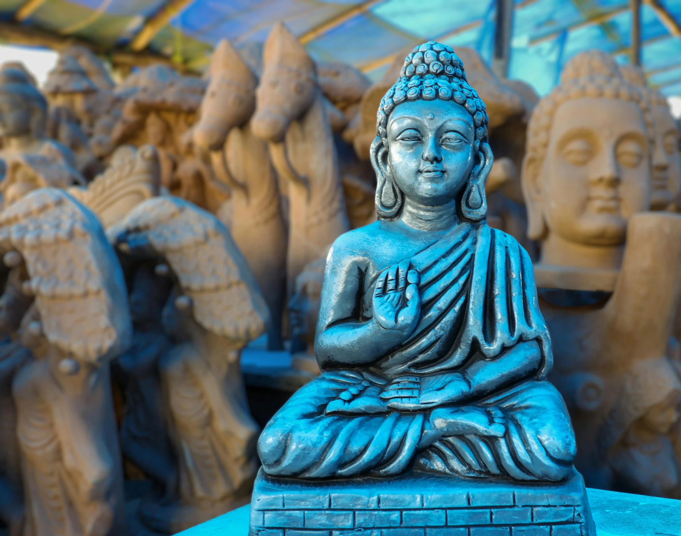 a statue of a buddha sitting on top of a table, a statue, by Sam Dillemans, pexels contest winner, cloisonnism, shades of blue and grey, temple fair, thumbnail, various posed