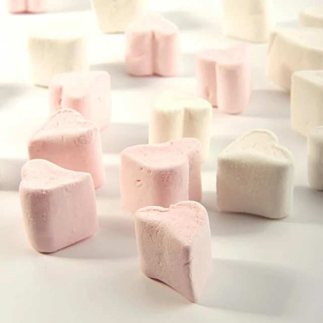 a white table topped with lots of pink and white marshmallows, 6 pack, gotic harts, solid coloured shapes, thumbnail