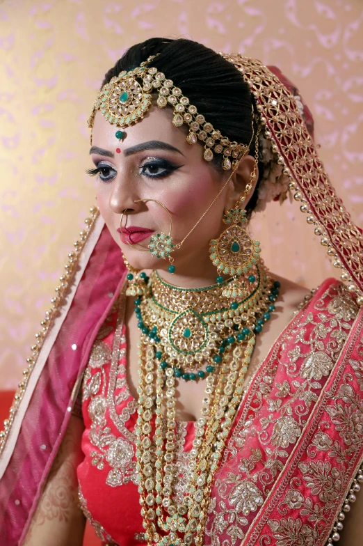 a woman dressed in a red and gold outfit, a portrait, inspired by Saurabh Jethani, pexels contest winner, turquoise pink and green, thumbnail, bride, wearing gold chain