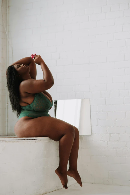 a woman in a green bikini sitting on a window sill, by Dulah Marie Evans, curvaceous, profile image, in bathroom, bralette