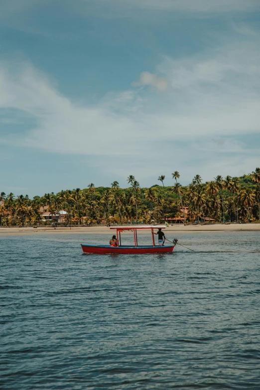 a red boat floating on top of a body of water, palm trees on the beach, 2 people, colombian, slide show