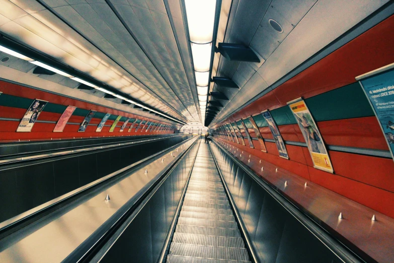 a long red train traveling down a train track, an album cover, inspired by Thomas Struth, unsplash, hyperrealism, escalators, inside a spaceship, underground city, multicoloured