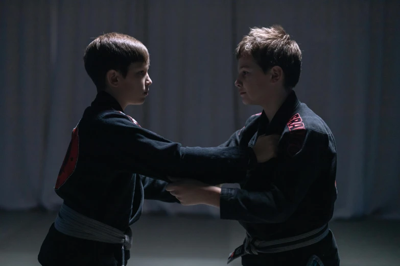a couple of young men standing next to each other, by Emma Andijewska, pexels contest winner, symbolism, martial arts tournament, 2 0 2 1 cinematic 4 k framegrab, cute boys, fighting each other