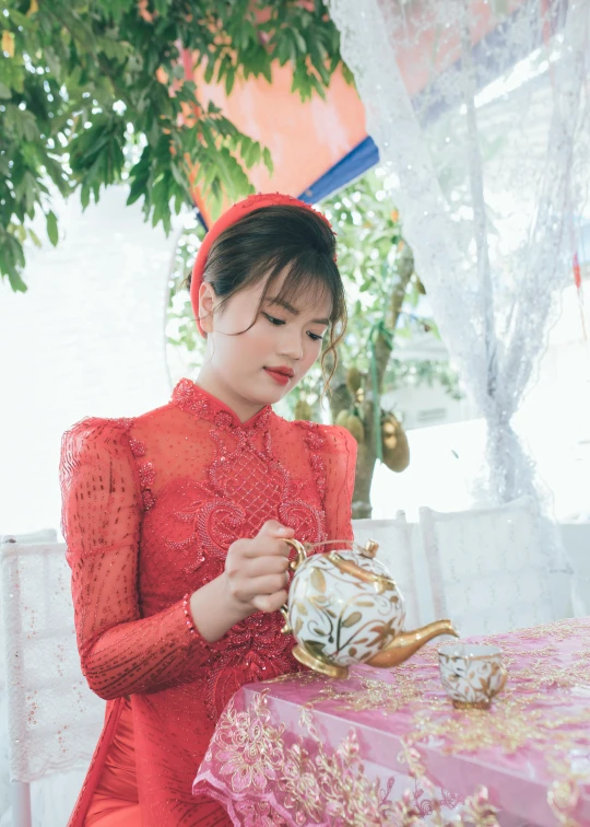 a woman in a red dress sitting at a table, by Tan Ting-pho, pexels contest winner, happening, teapot, ao dai, gif, square