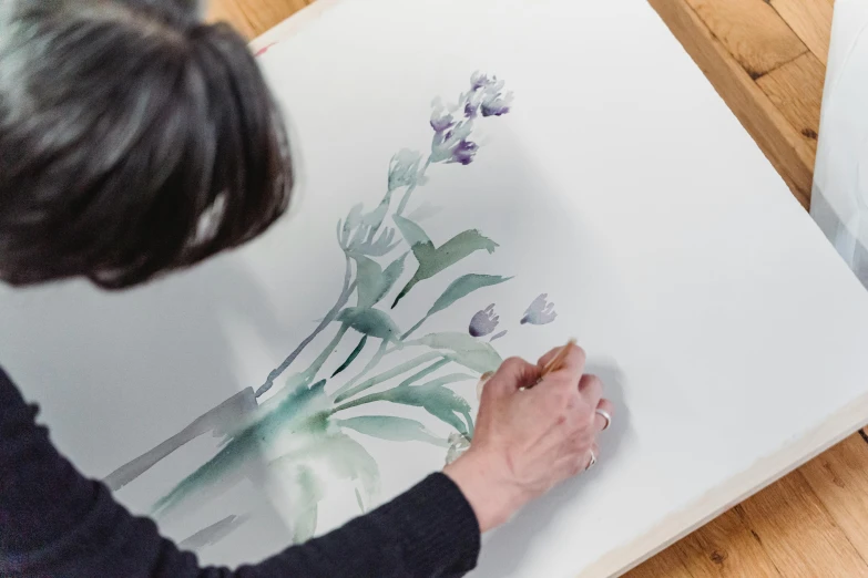 a woman is painting flowers on a canvas, inspired by Ryōhei Koiso, medium-format print, botanicals, on paper, commission