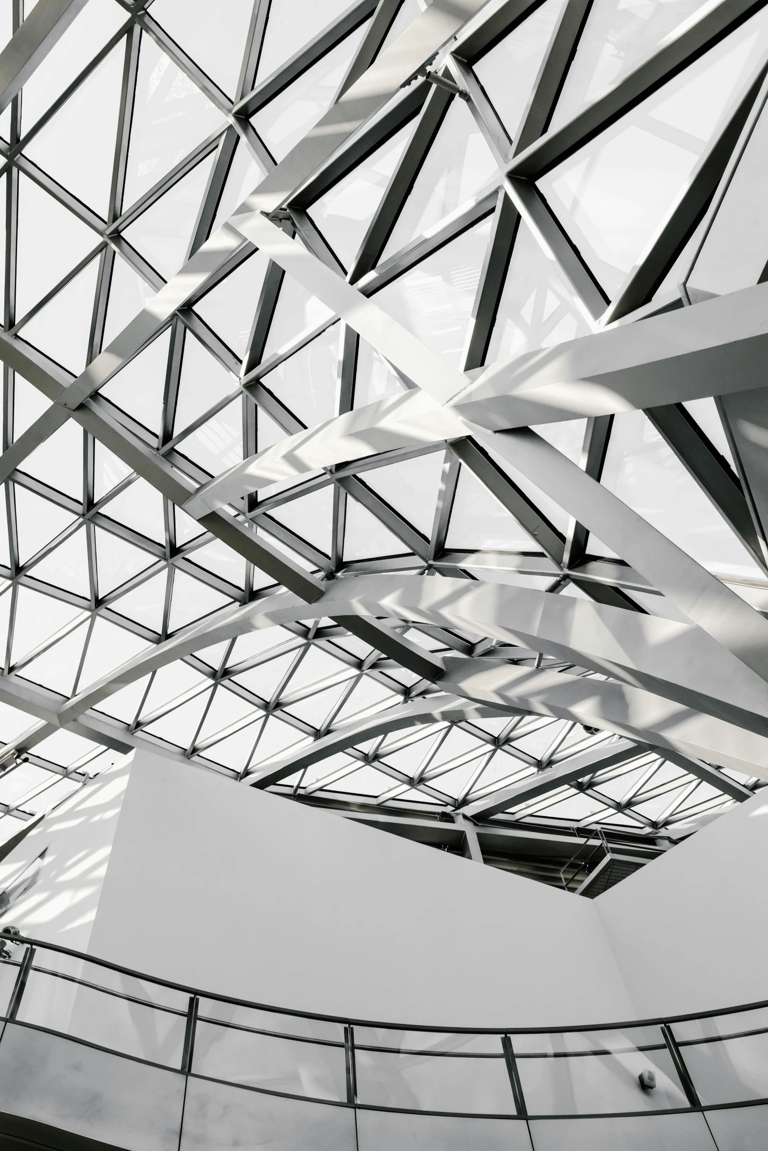 a black and white photo of the inside of a building, inspired by Zaha Hadid, unsplash contest winner, light and space, geodesic, roof with vegetation, glossy white metal, angular metal