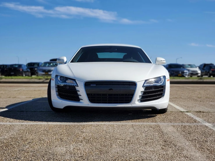 a white sports car parked in a parking lot, unsplash, photorealism, full front view, unedited, in 2 0 1 2, instagram picture