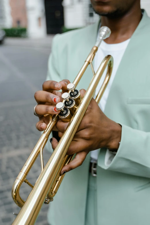 a close up of a person holding a trumpet, wearing a light blue suit, 2019 trending photo, brass woman, b - roll