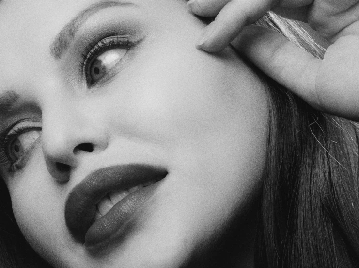 a black and white photo of a woman brushing her hair, inspired by George Hurrell, nose of angelina jolie, dark red lips, animatronic angelina jolie, profile image