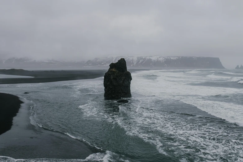 a large rock in the middle of a body of water, pexels contest winner, overcast gray skies, iceland, movie still 8 k, frozen sea