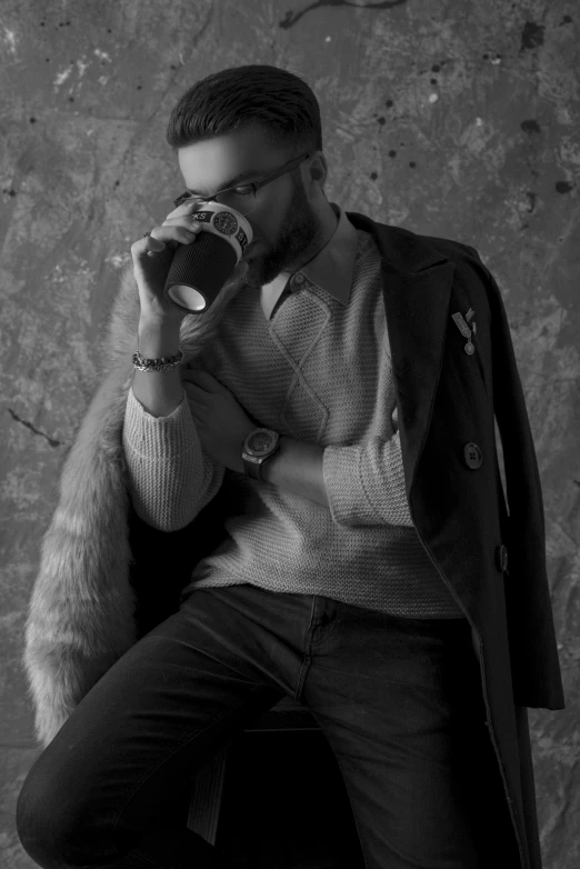 a black and white photo of a man holding a camera, inspired by Peter Lindbergh, renaissance, holding a drink, fashion shoot, bearded, sittin