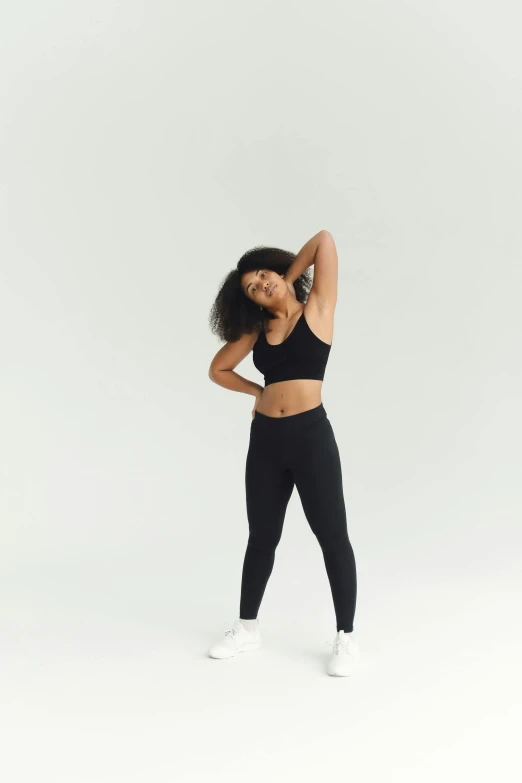 a woman in a black sports bra top and leggings, by Dulah Marie Evans, view(full body + zoomed out), default pose neutral expression, black in, panoramic view of girl