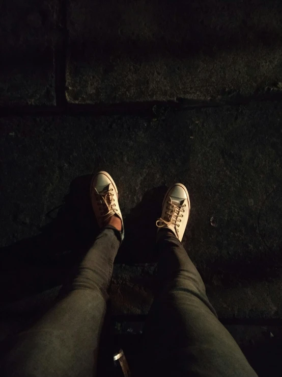 a person standing on a sidewalk at night, inspired by Elsa Bleda, shoes, teenage, ( ( theatrical ) ), instagram post