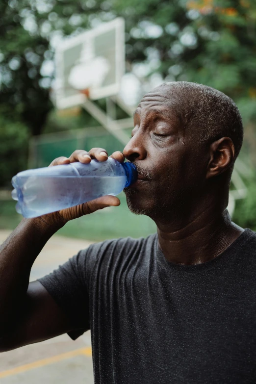 a man drinking water from a plastic bottle, pexels contest winner, renaissance, african american, photo of a 50-year-old white man, profile image, athletic muscle tone