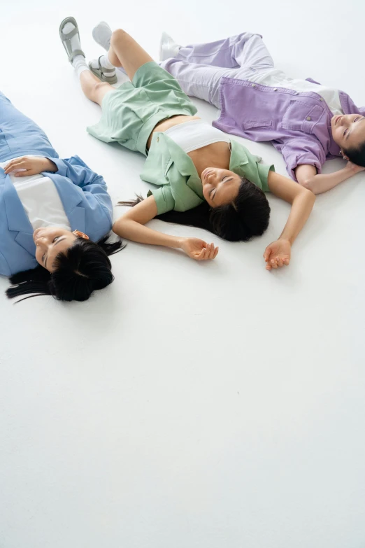 a group of people laying on top of a white floor, by Tadashige Ono, sleepwear, けもの, three head one body, soft cool colors