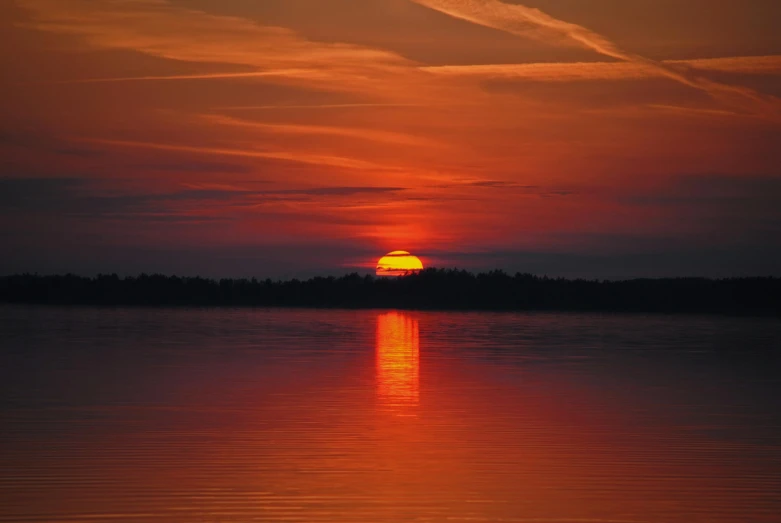 a large body of water with a sunset in the background, by Jan Tengnagel, pexels contest winner, vermilion and red lake, big red sun, from wheaton illinois, good night