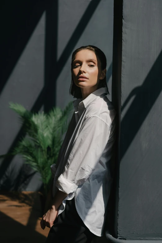 a woman in a white shirt and black pants, inspired by Elsa Bleda, pexels contest winner, bauhaus, portrait sophie mudd, light coming in from the left, androgynous person, portrait of tall