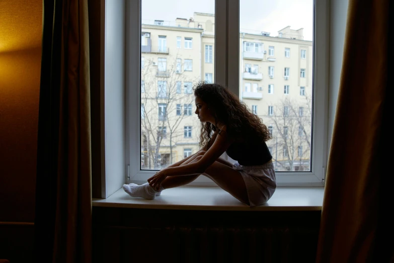 a woman sitting on top of a window sill, pexels contest winner, arabesque, hugging her knees, angelina stroganova, what depression looks like, profile image